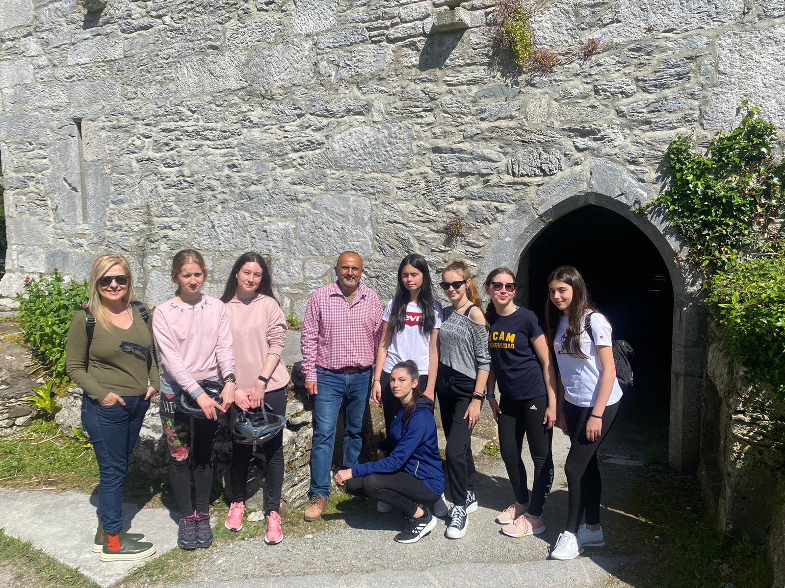 A group visiting a historic stone building