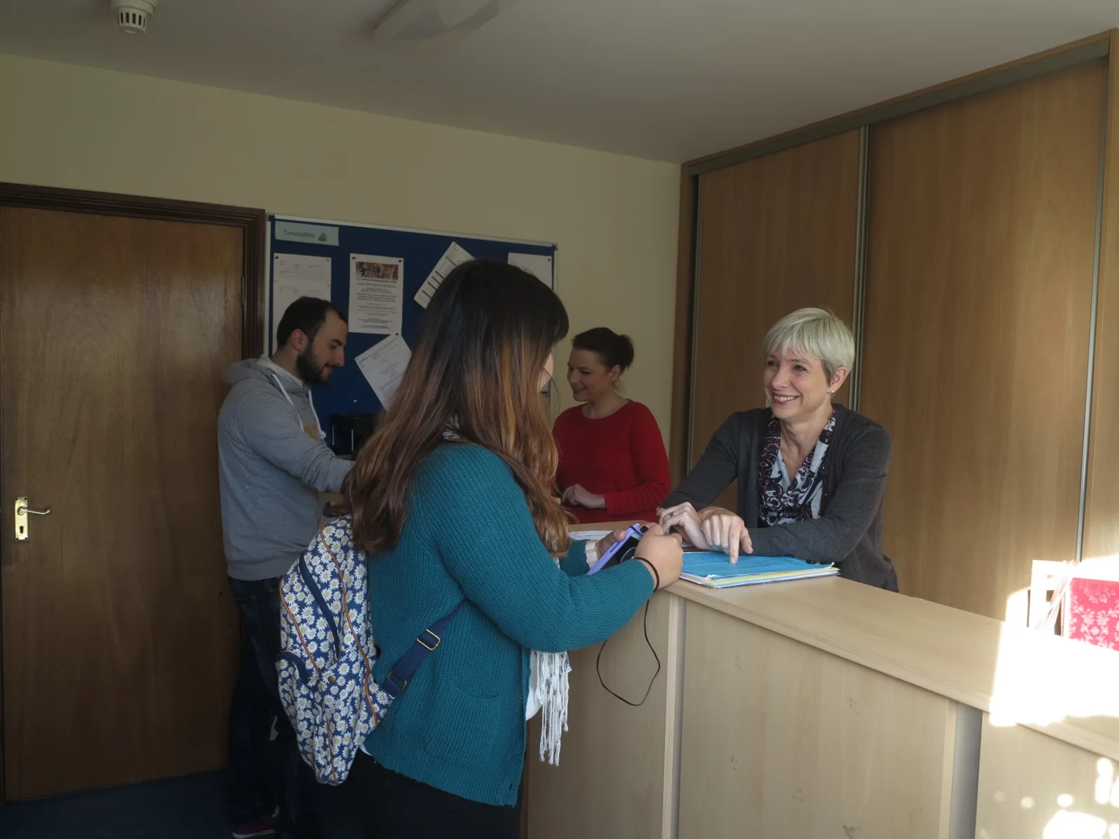 A student receiving a friendly welcome at the school reception