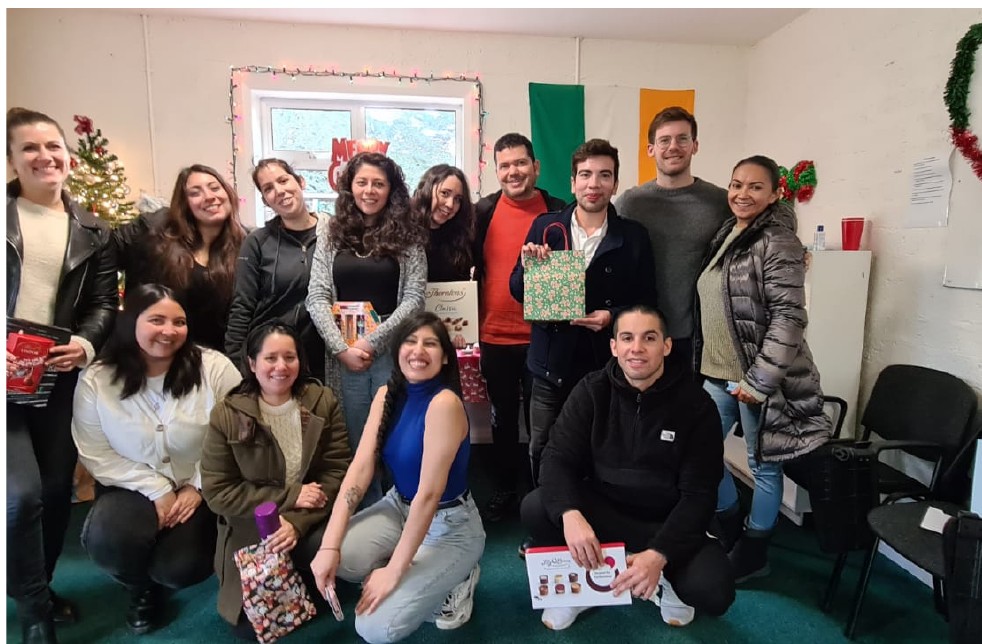 Adult students together in a classroom with an Irish flag