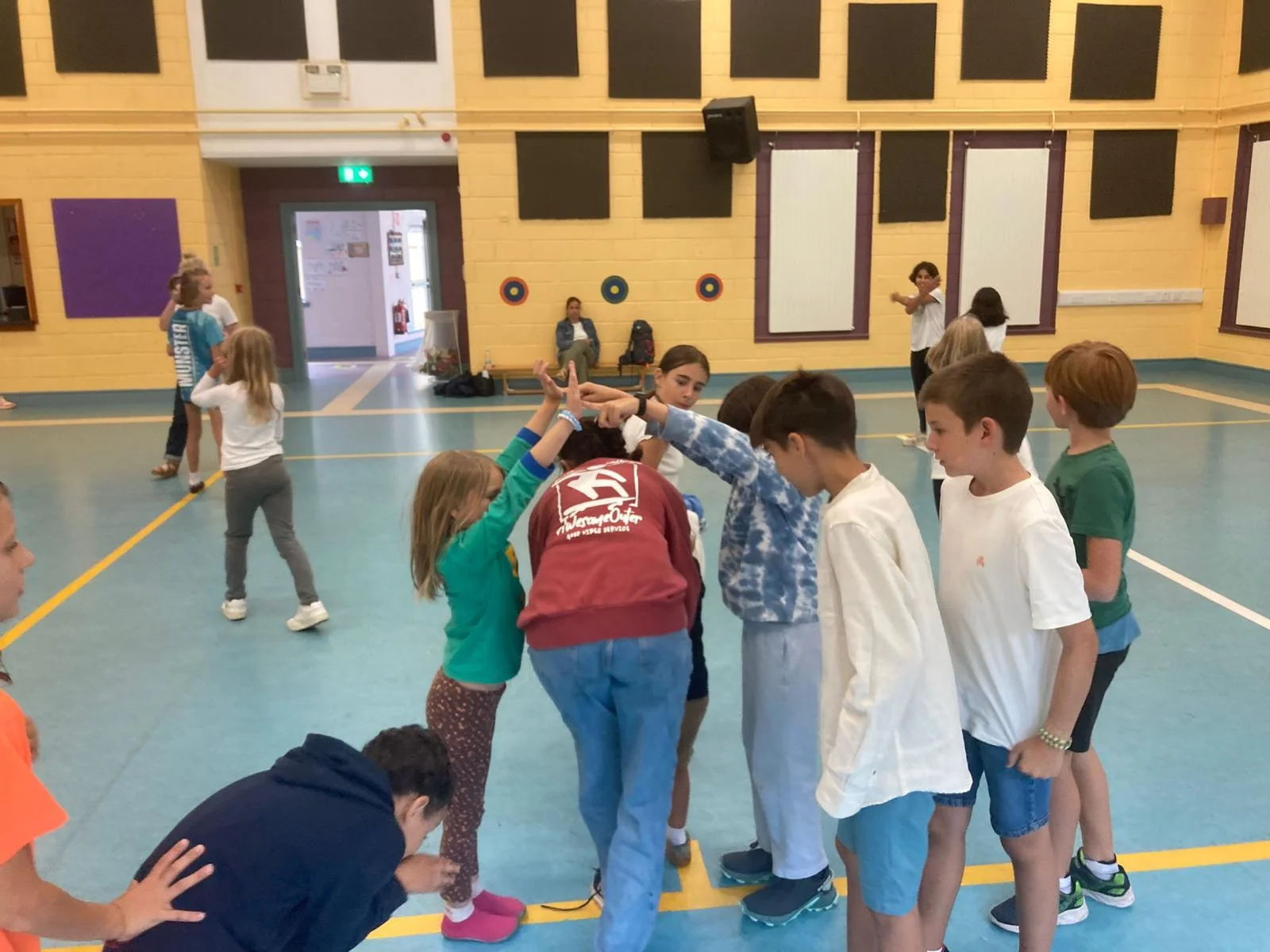 Children playing a group game in the school hall