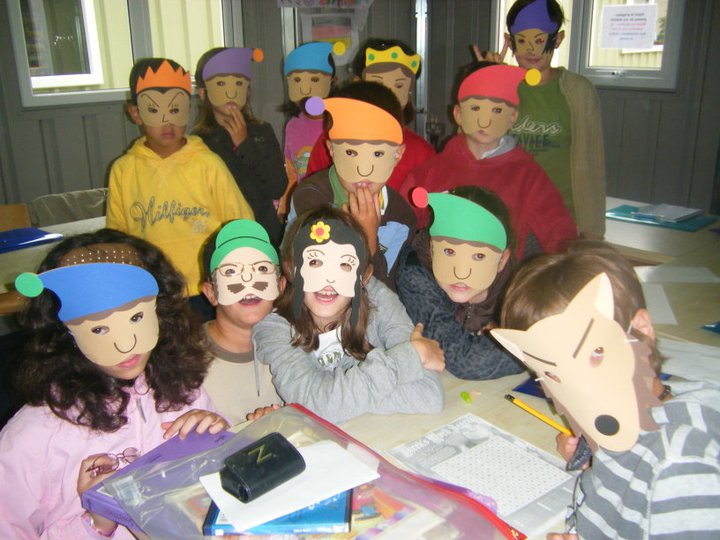 Children enjoying a classroom activity wearing colourful masks