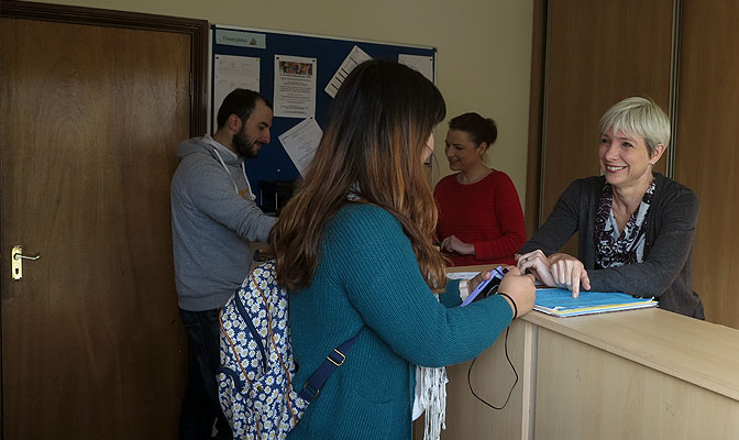 Adult students speaking together in class