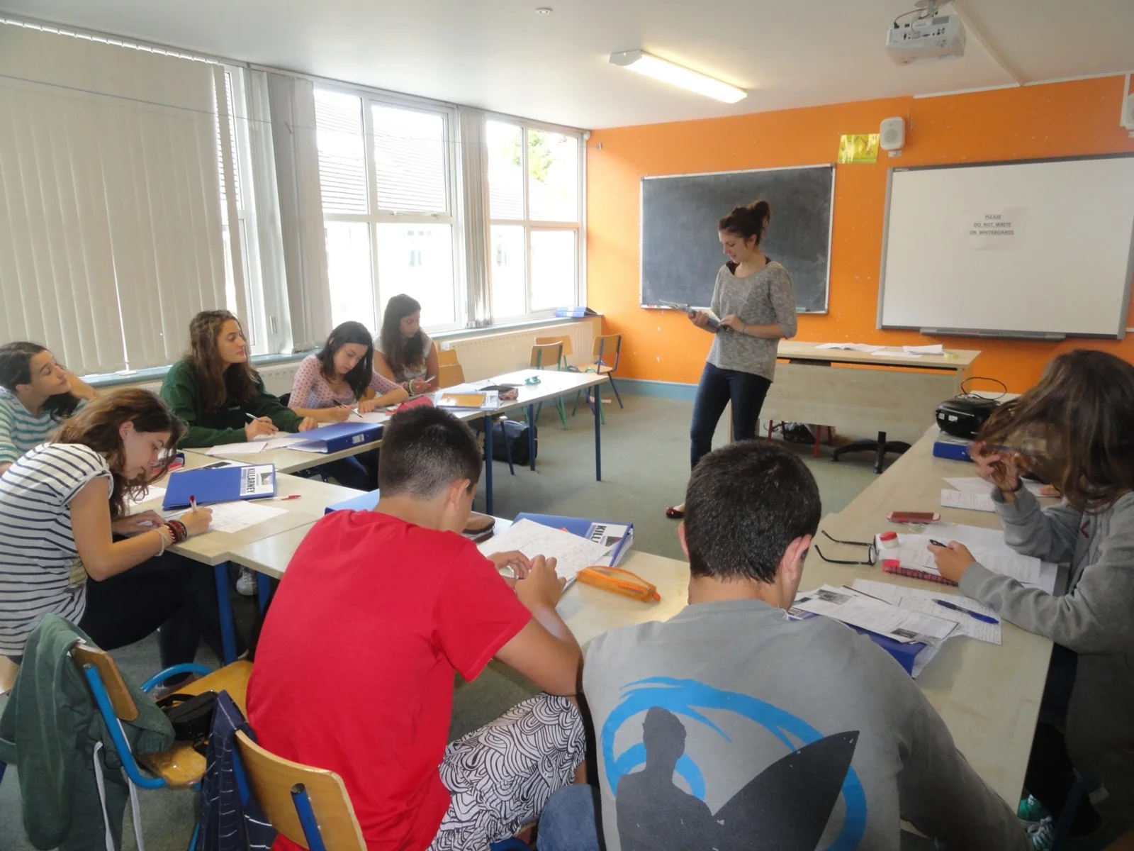 Teenage students taking part in an English lesson