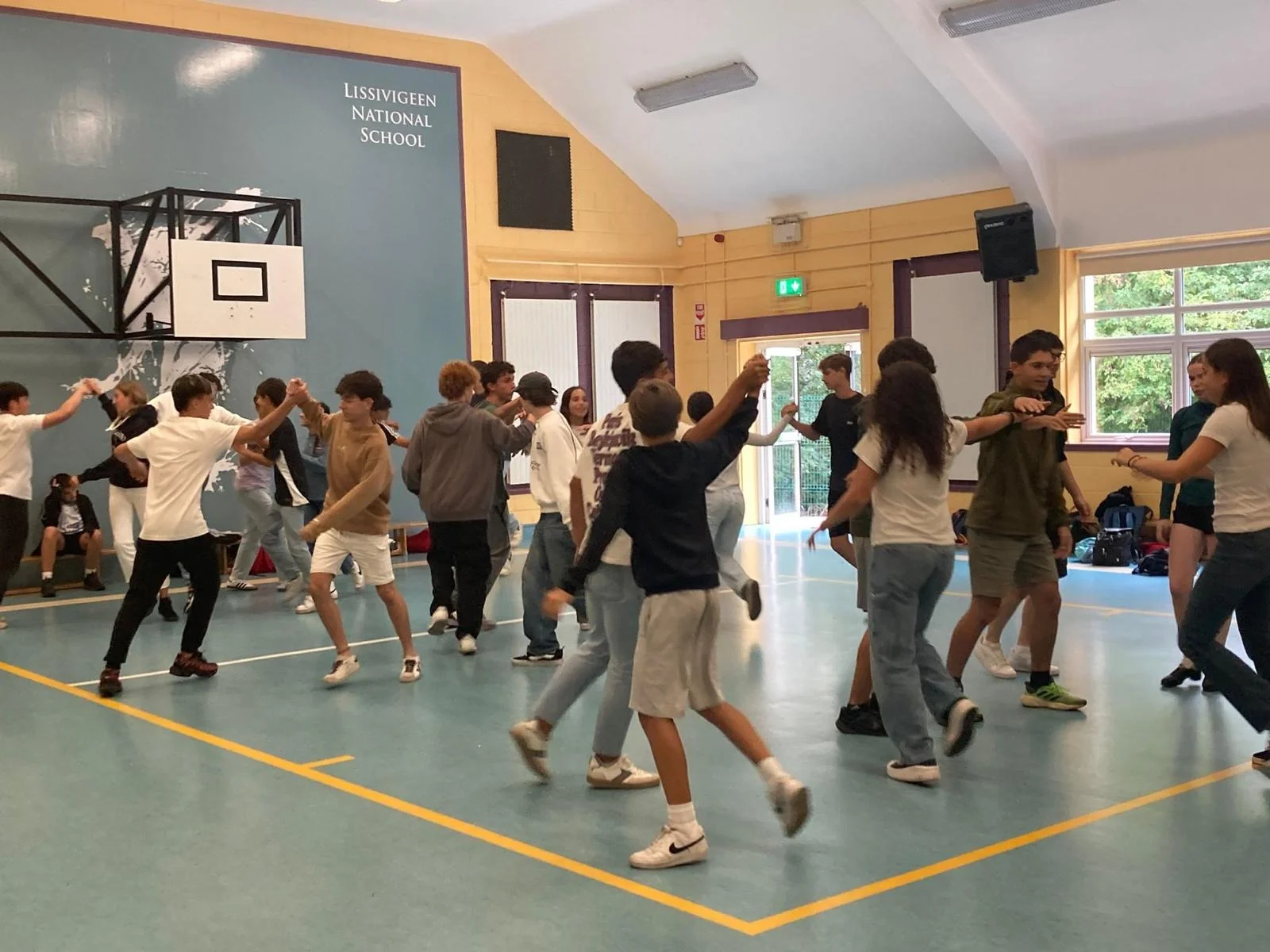 Teenage students enjoying a group activity in the school hall